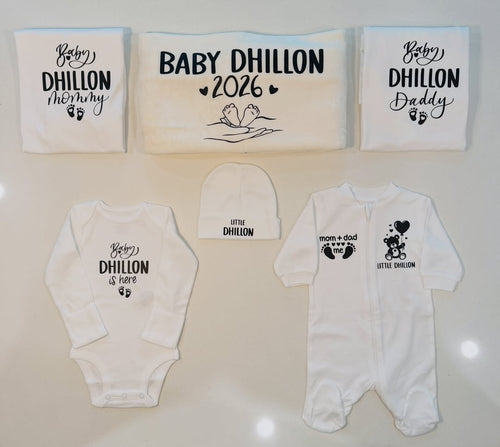Personalized newborn gift set with custom family name printed on white onesie, sleepsuit, hat, and matching mommy and daddy items
